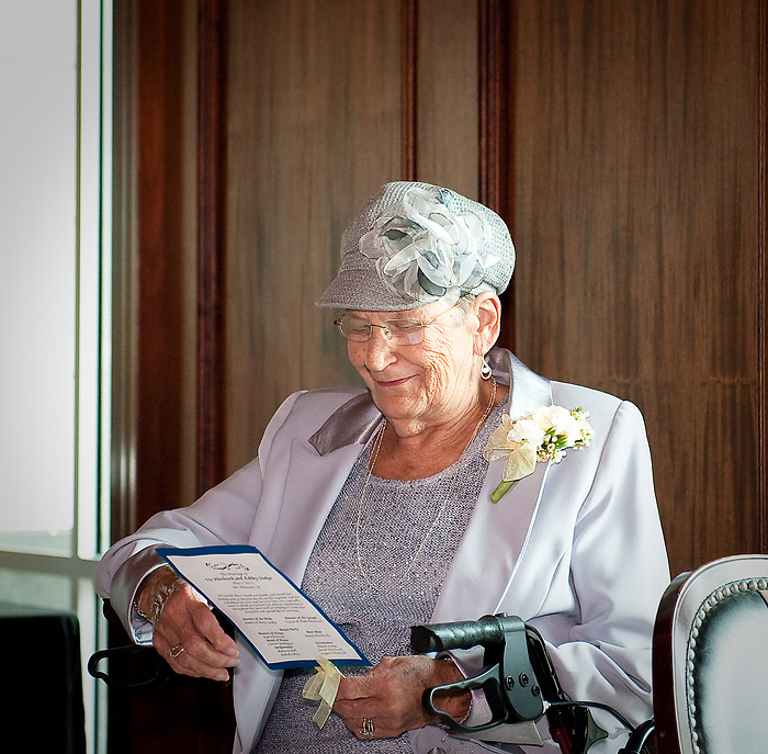 The senior lady is reading the menu